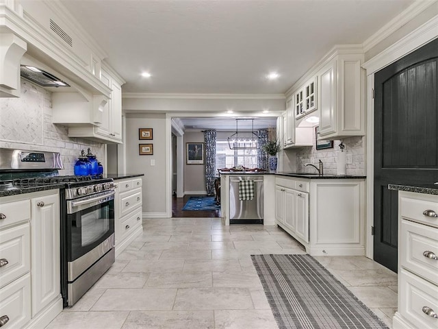 kitchen with white cabinetry, decorative light fixtures, stainless steel appliances, and decorative backsplash