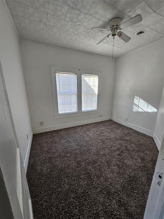 spare room featuring carpet floors and ceiling fan