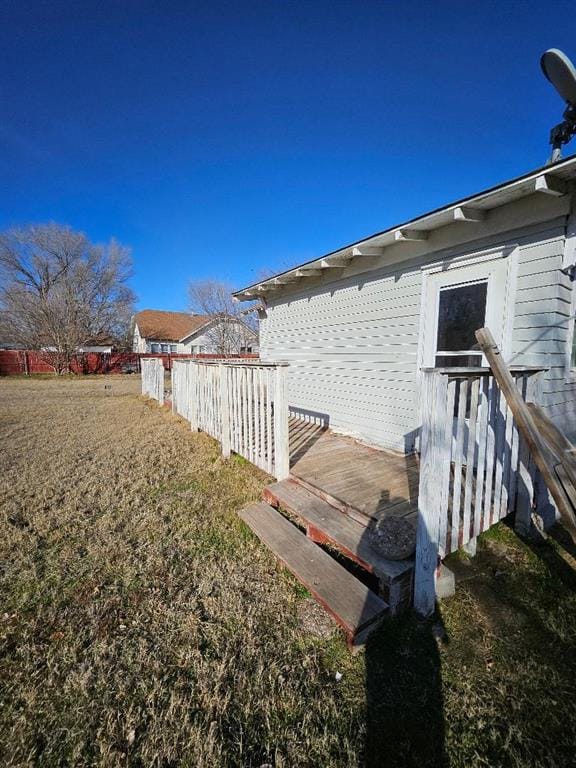 view of property exterior with a wooden deck