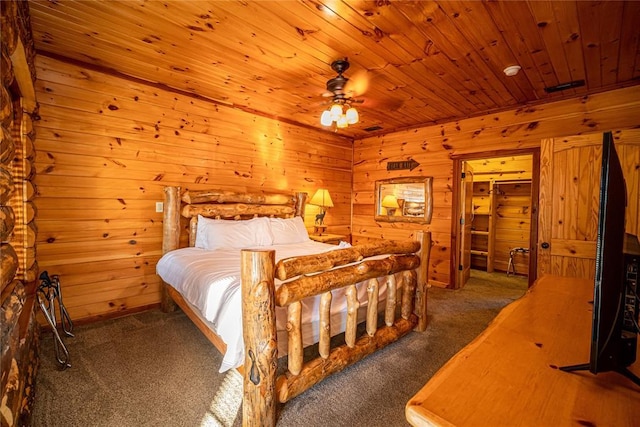 carpeted bedroom with wooden walls and wooden ceiling