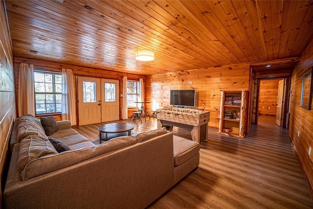 living room featuring hardwood / wood-style floors, wood ceiling, and wood walls