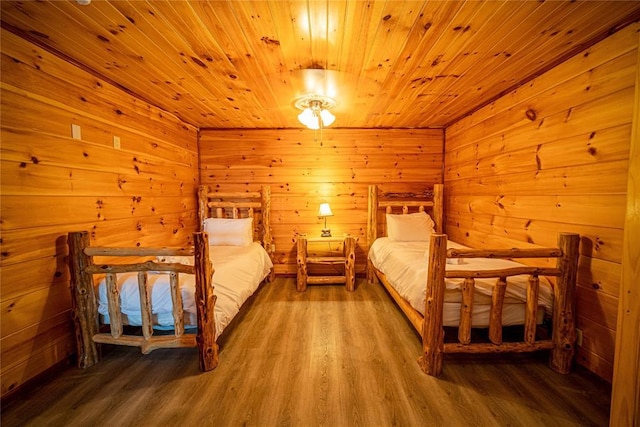 unfurnished bedroom featuring hardwood / wood-style floors, wood ceiling, and wooden walls