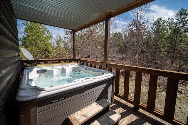 wooden deck featuring a hot tub