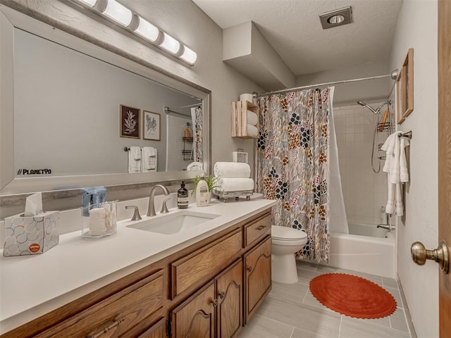 2108 Barton St Unit 2110, Norman, OK 73072 - bathroom featuring a textured ceiling, shower / bathtub combination with curtain, vanity, tile patterned flooring, and toilet