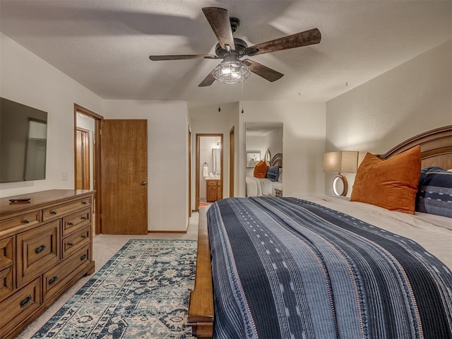 2108 Barton St Unit 2110, Norman, OK 73072 - bedroom featuring ensuite bathroom, a textured ceiling, and ceiling fan