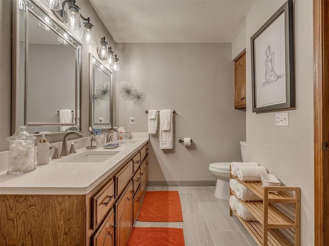 2108 Barton St Unit 2110, Norman, OK 73072 - full bath with a sink, toilet, double vanity, and baseboards
