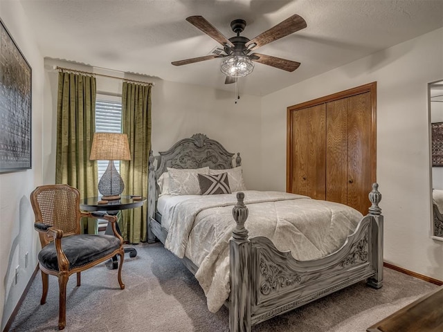 2108 Barton St Unit 2110, Norman, OK 73072 - bedroom featuring a closet, baseboards, a textured ceiling, a ceiling fan, and carpet
