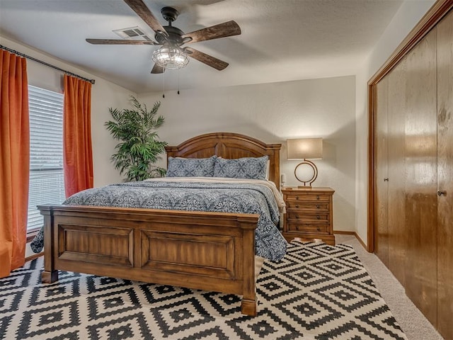 2108 Barton St Unit 2110, Norman, OK 73072 - bedroom featuring a closet, baseboards, visible vents, a ceiling fan, and carpet floors