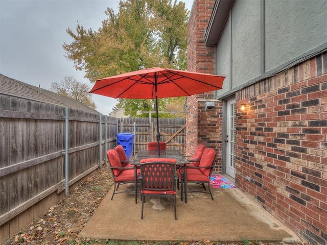 2108 Barton St Unit 2110, Norman, OK 73072 - view of patio with outdoor dining space and a fenced backyard