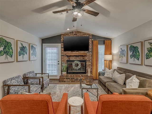 2108 Barton St Unit 2110, Norman, OK 73072 - living area featuring visible vents, a brick fireplace, a ceiling fan, and vaulted ceiling