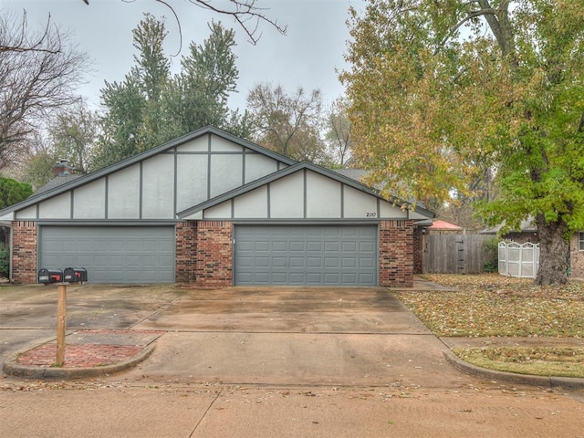 2108 Barton St Unit 2110, Norman, OK 73072 - view of front of house with brick siding, an attached garage, fence, and driveway