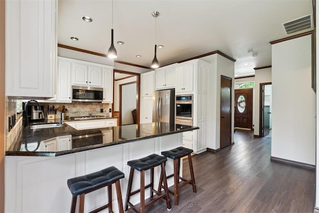 1408 NW 147th St, Edmond, OK 73013 - kitchen featuring appliances with stainless steel finishes, a peninsula, ornamental molding, backsplash, and dark wood-type flooring