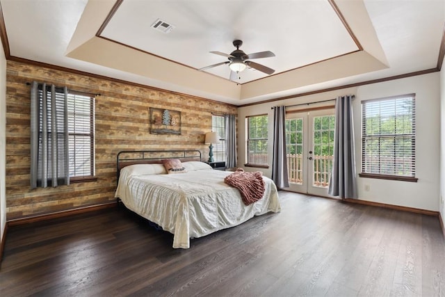 1408 NW 147th St, Edmond, OK 73013 - bedroom with a raised ceiling, access to exterior, wood walls, dark wood finished floors, and french doors