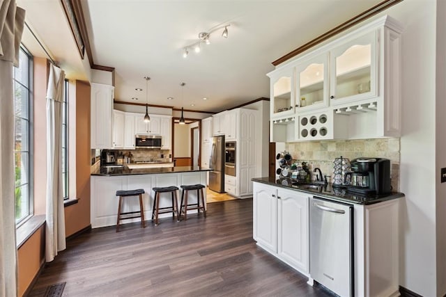 1408 NW 147th St, Edmond, OK 73013 - kitchen with appliances with stainless steel finishes, dark countertops, a peninsula, backsplash, and glass insert cabinets