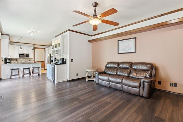 1408 NW 147th St, Edmond, OK 73013 - living area with dark wood finished floors, a ceiling fan, and ornamental molding