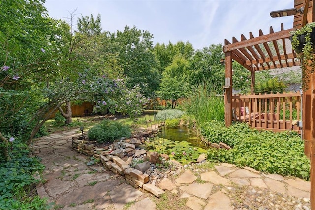 1408 NW 147th St, Edmond, OK 73013 - view of yard featuring a pergola and a garden pond