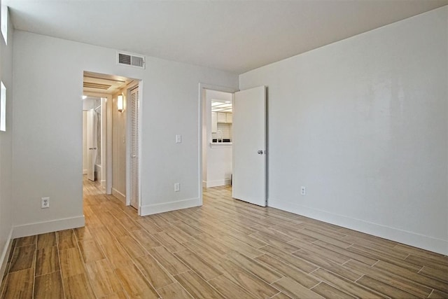 unfurnished bedroom with a closet and light hardwood / wood-style flooring