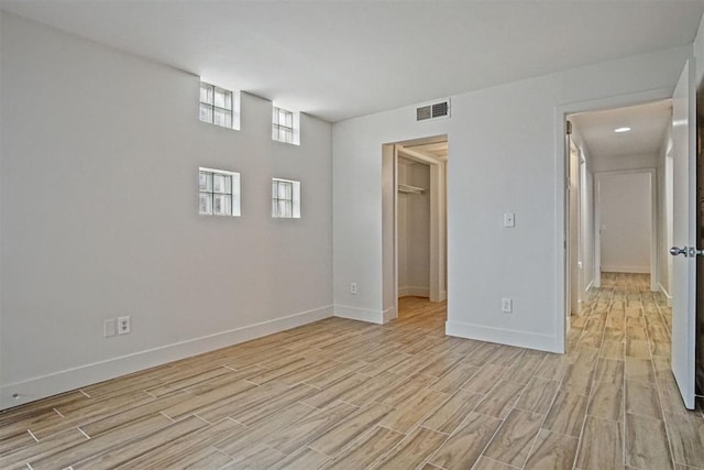 empty room with light hardwood / wood-style flooring