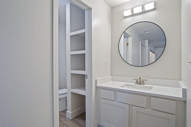 bathroom featuring vanity and toilet