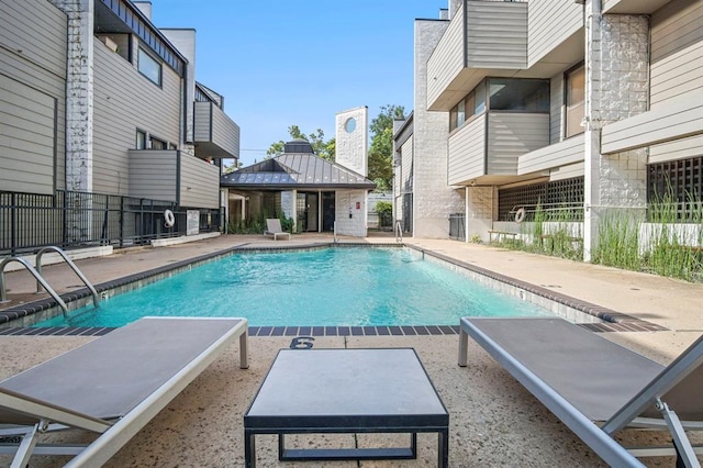 view of swimming pool with a gazebo and a patio area