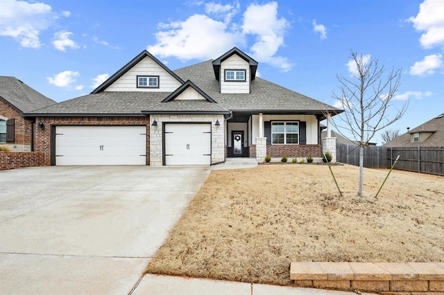 view of front facade with a shingled roof, concrete driveway, an attached garage, fence, and brick siding