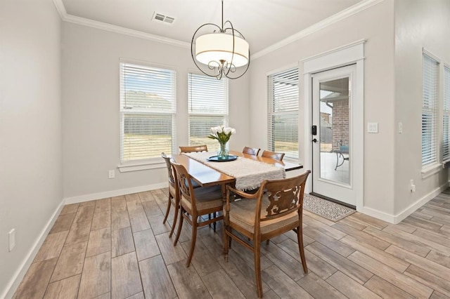 dining space with ornamental molding, wood finish floors, visible vents, and baseboards