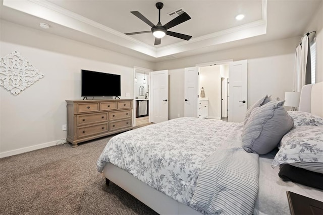 bedroom featuring light carpet, visible vents, a raised ceiling, and ornamental molding