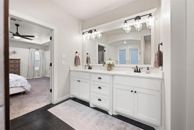 bathroom featuring ensuite bathroom, ceiling fan, a sink, visible vents, and double vanity