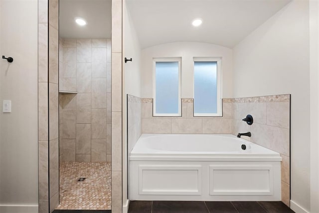 full bath featuring a garden tub, recessed lighting, vaulted ceiling, tile patterned floors, and walk in shower