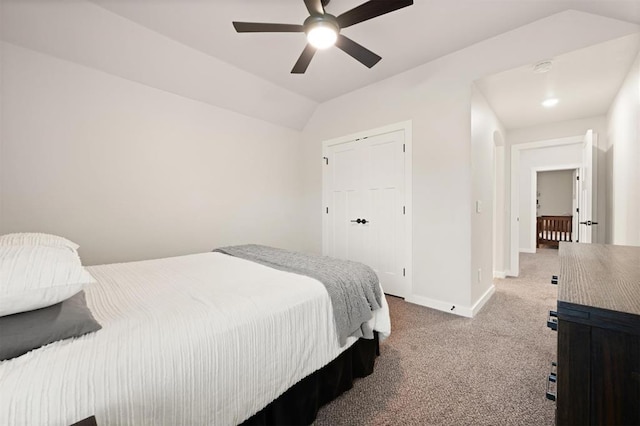 bedroom with ceiling fan, baseboards, vaulted ceiling, and carpet flooring