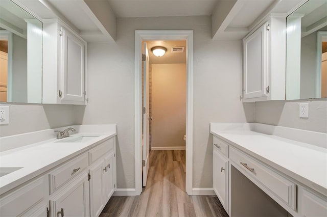 laundry room with sink and light hardwood / wood-style flooring