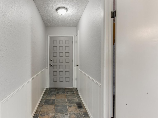 entryway featuring a textured ceiling