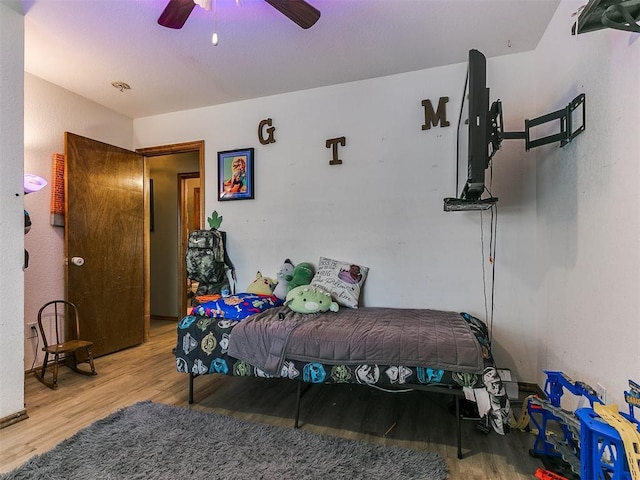 bedroom with wood-type flooring and ceiling fan