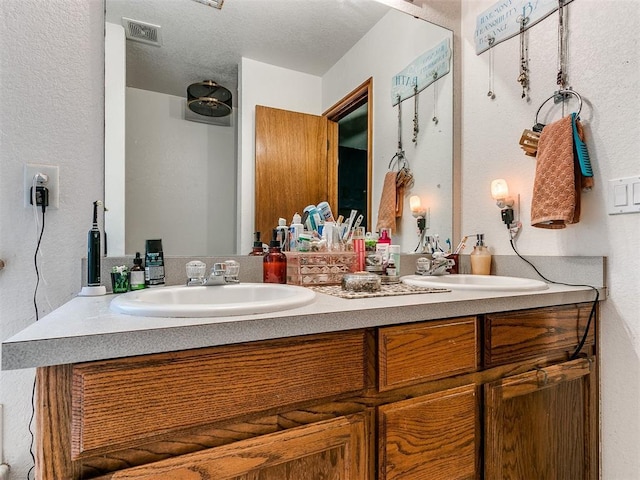 bathroom with vanity and a textured ceiling