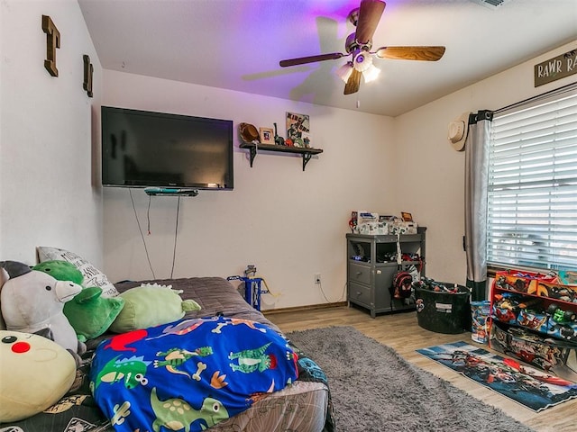 bedroom with ceiling fan and light hardwood / wood-style floors