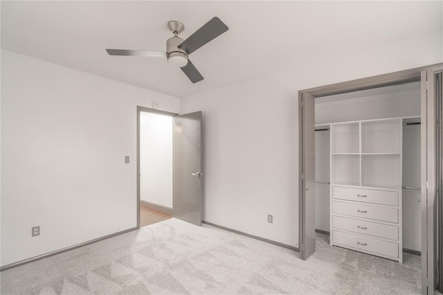 unfurnished bedroom featuring light colored carpet, a closet, and ceiling fan