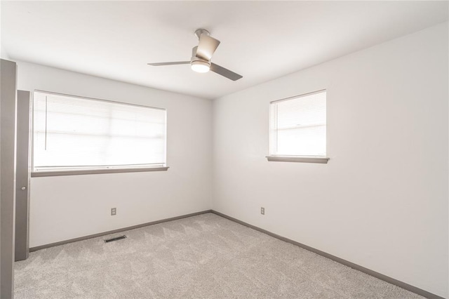 empty room featuring light carpet and ceiling fan