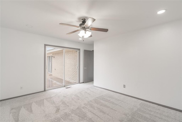 empty room featuring light colored carpet and ceiling fan