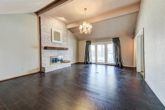 unfurnished living room with a notable chandelier, lofted ceiling with beams, a fireplace, french doors, and dark wood-type flooring