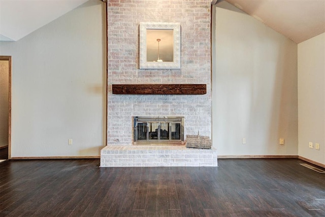 unfurnished living room featuring baseboards, wood finished floors, a brick fireplace, and lofted ceiling