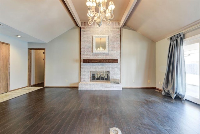 unfurnished living room featuring a chandelier, wood finished floors, lofted ceiling with beams, and a brick fireplace