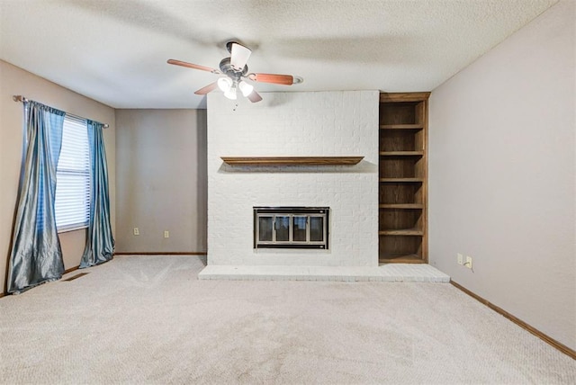 unfurnished living room featuring ceiling fan, carpet flooring, baseboards, and a fireplace