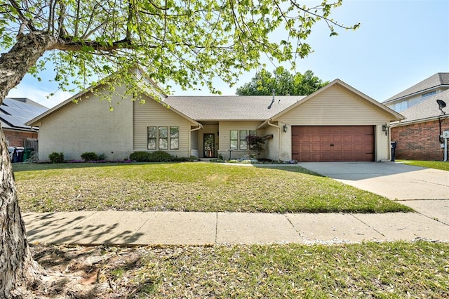ranch-style home featuring brick siding, a front yard, a garage, and concrete driveway