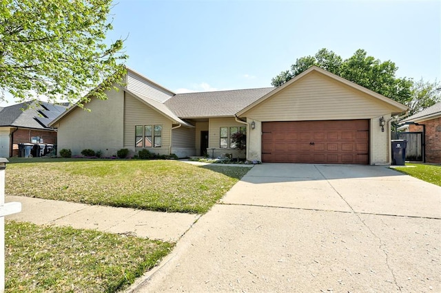 view of front of home with concrete driveway, brick siding, a front lawn, and an attached garage