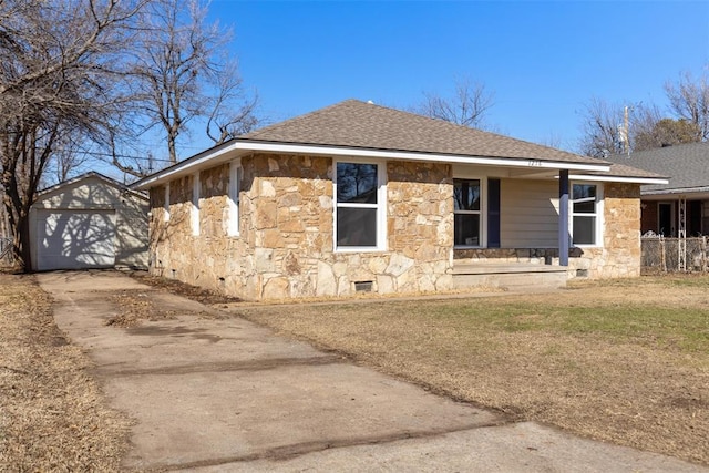 view of side of property with a garage, a porch, a yard, and an outbuilding