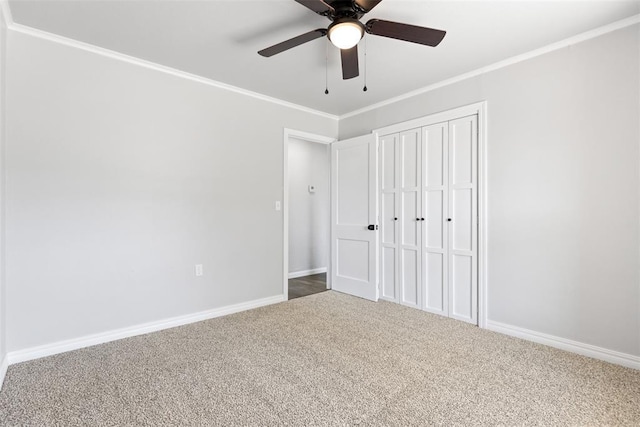 unfurnished bedroom with ceiling fan, ornamental molding, carpet floors, and a closet