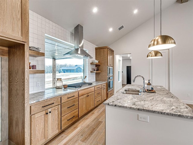 kitchen featuring pendant lighting, sink, appliances with stainless steel finishes, light stone counters, and island range hood