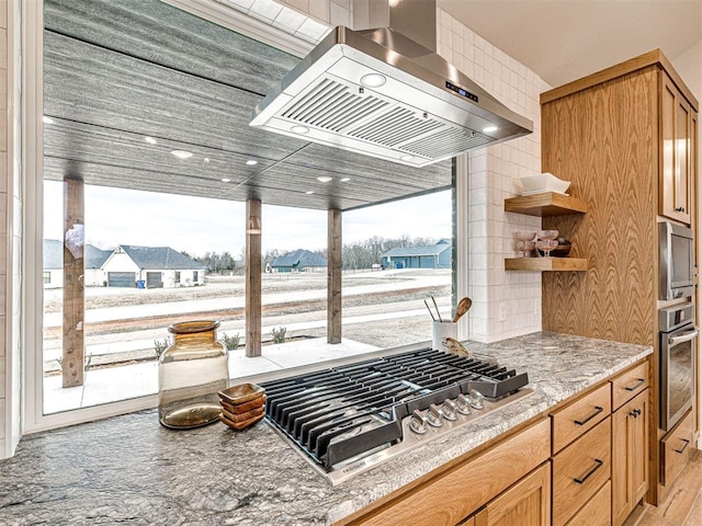 kitchen with stainless steel appliances and range hood