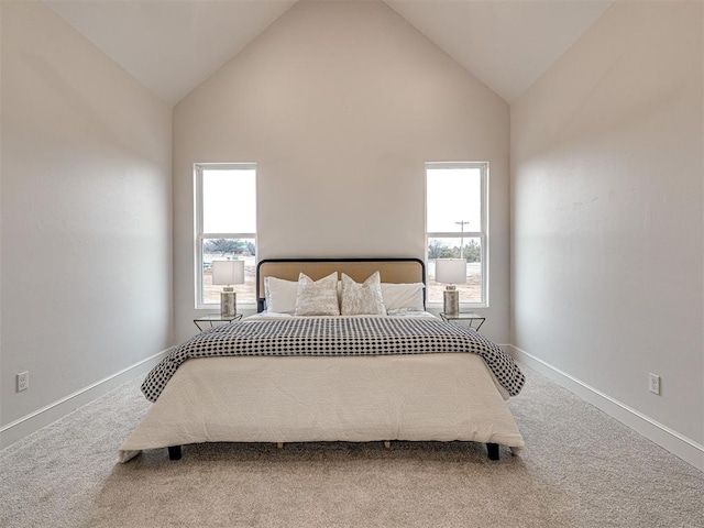 bedroom with multiple windows, carpet flooring, and high vaulted ceiling