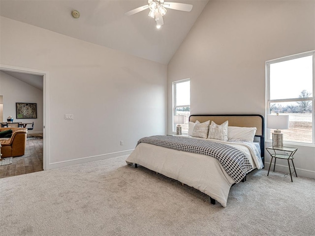 bedroom featuring multiple windows, ceiling fan, carpet flooring, and high vaulted ceiling